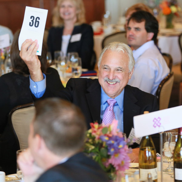 man holding placard at auction